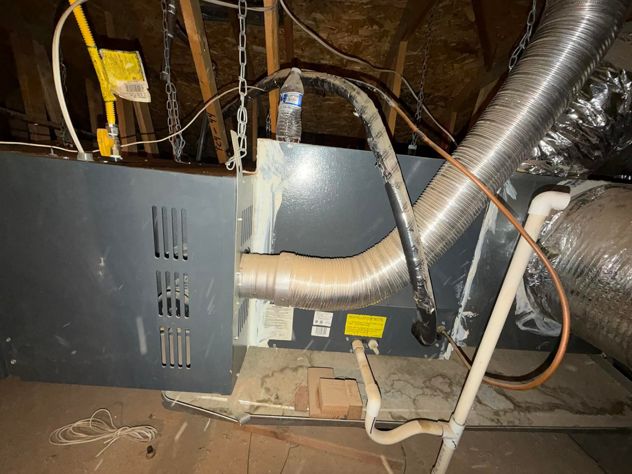 Old attic furnace and flexible ductwork before an Outlaw Air replacement
